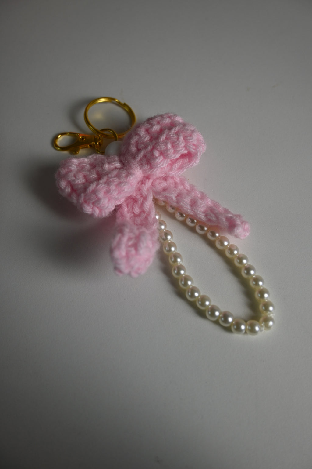“handmade crochet pink bow keychain with pearl beads