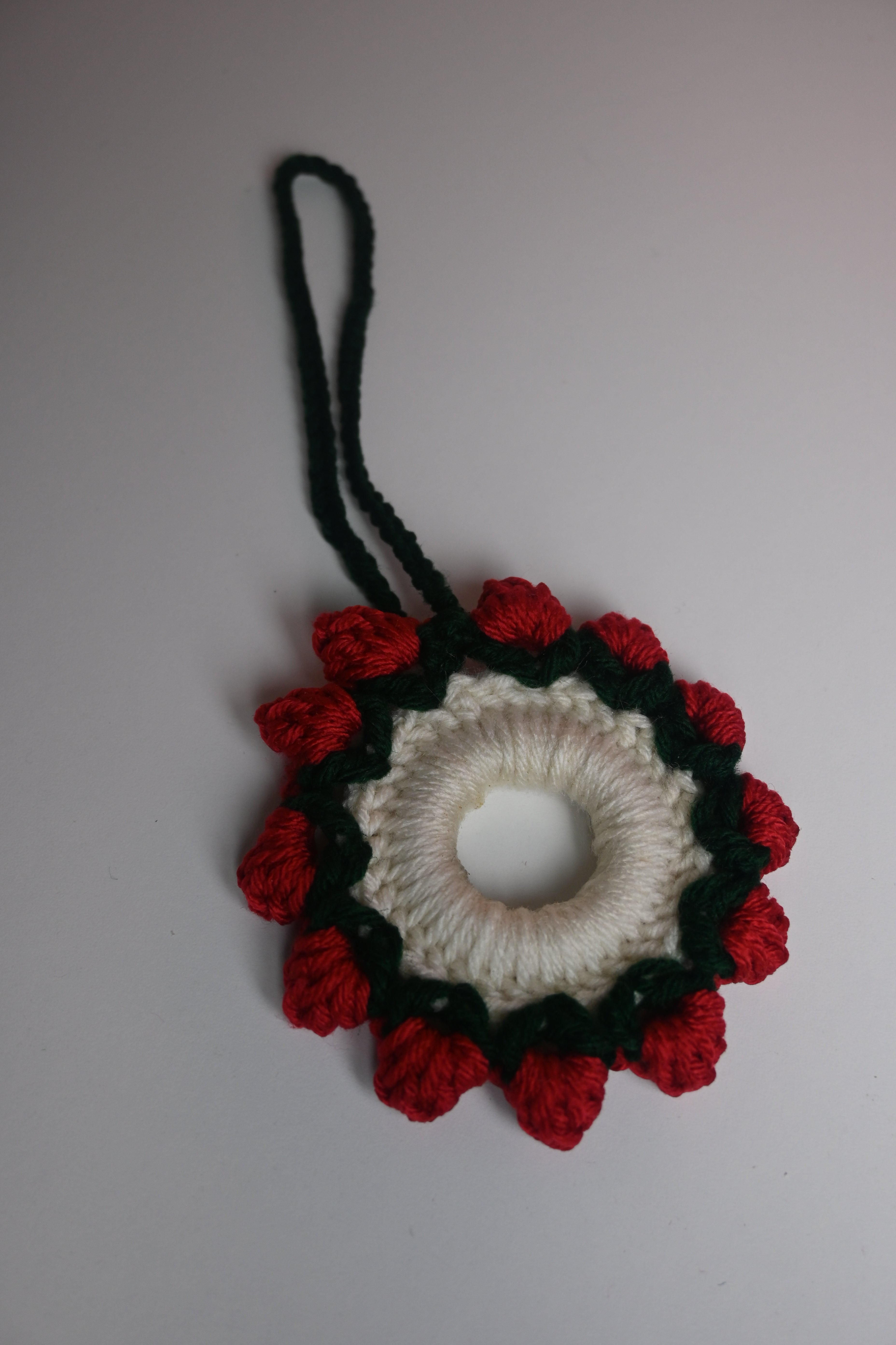“Handmade red crochet rearview mirror charm floral design”
